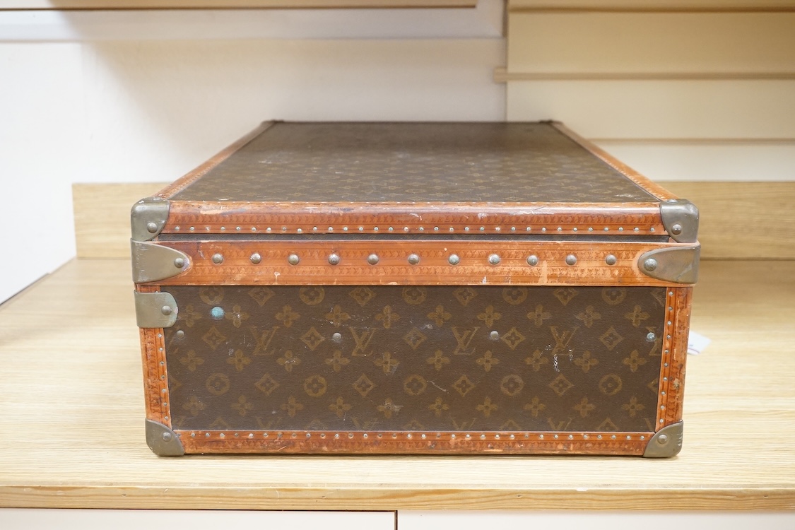 A vintage Louis Vuitton monogram suitcase with two original keys, numbered 793692 to the linen covered interior, height 22cm, width 76cm, depth 46cm